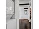 Laundry Room showcasing a stackable washer and dryer near a doorway with hardwood floors at 1747 Parkhill Dr, Decatur, GA 30032