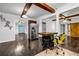 Open living room featuring hardwood floors, stainless steel appliances, beamed ceilings, and a decorative barn door at 1747 Parkhill Dr, Decatur, GA 30032