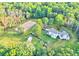 Expansive equestrian estate with sprawling grounds, horse riding area, and custom-built home amid lush greenery at 2203 Arbor Hill Rd, Canton, GA 30115