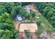 A beautiful estate featuring a custom home with a riding area and lush green trees surrounding the property at 2203 Arbor Hill Rd, Canton, GA 30115