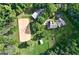 Aerial view of the equestrian estate showcasing a home, riding arena, barn and surrounding landscape at 2203 Arbor Hill Rd, Canton, GA 30115