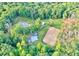 A private estate featuring a custom-built home with an horse-riding area surrounded by mature trees at 2203 Arbor Hill Rd, Canton, GA 30115