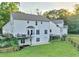Expansive backyard with a white two-story home, deck, and mature landscaping at 2203 Arbor Hill Rd, Canton, GA 30115