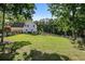 Expansive backyard with lush green lawn, wooden fence, and mature trees at 2203 Arbor Hill Rd, Canton, GA 30115