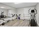 Basement gym features an elliptical, exercise bikes, rowing machine, and mirrored wall at 2203 Arbor Hill Rd, Canton, GA 30115