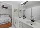 Bright bathroom featuring a double sink vanity with modern lighting and a view into the primary bedroom at 2203 Arbor Hill Rd, Canton, GA 30115