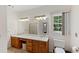 Bathroom featuring double sinks, wood cabinets, and a window at 2203 Arbor Hill Rd, Canton, GA 30115