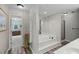 Bright bathroom featuring a luxurious soaking tub, shower and vanity with modern lighting at 2203 Arbor Hill Rd, Canton, GA 30115