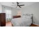Bedroom with wood floors, large window, neutral walls, and modern ceiling fan at 2203 Arbor Hill Rd, Canton, GA 30115