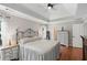 Spacious bedroom with wood floors, crown moulding, tray ceiling and a decorative wrought iron headboard at 2203 Arbor Hill Rd, Canton, GA 30115