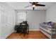Bedroom with hardwood floors, large closet, and modern ceiling fan at 2203 Arbor Hill Rd, Canton, GA 30115