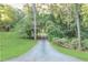 Long private driveway leading to the estate, surrounded by mature trees and lush greenery on both sides at 2203 Arbor Hill Rd, Canton, GA 30115