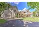 Inviting home boasts a manicured lawn, mature trees, and a covered porch perfect for relaxing or entertaining guests at 2203 Arbor Hill Rd, Canton, GA 30115