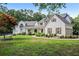 Charming two-story home with a cozy front porch, well-manicured lawn, and beautiful landscaping at 2203 Arbor Hill Rd, Canton, GA 30115
