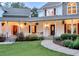 Inviting front porch with detailed trim, hanging plants, and comfortable seating for enjoying the outdoors at 2203 Arbor Hill Rd, Canton, GA 30115