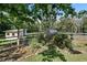 Garden area featuring raised beds, a greenhouse, and mature landscaping at 2203 Arbor Hill Rd, Canton, GA 30115