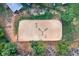 Aerial view of a large horse arena with sand, jumps, and surrounding greenery and trees at 2203 Arbor Hill Rd, Canton, GA 30115