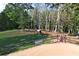 Picturesque horse paddock with black fencing and mature trees at 2203 Arbor Hill Rd, Canton, GA 30115