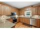 Well-appointed kitchen featuring wood cabinets, granite countertops, stainless steel appliances, and hardwood floors at 2203 Arbor Hill Rd, Canton, GA 30115