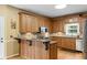 Well-lit kitchen with wood cabinets, granite countertops, stainless steel appliances and access to the backyard at 2203 Arbor Hill Rd, Canton, GA 30115