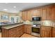 Kitchen featuring wood cabinets, granite countertops, stainless steel appliances, and a breakfast bar at 2203 Arbor Hill Rd, Canton, GA 30115
