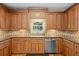 Charming kitchen featuring wood cabinetry, decorative backsplash, stainless steel appliances, and a window view at 2203 Arbor Hill Rd, Canton, GA 30115