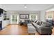 Spacious living room featuring a large sectional sofa, fireplace, built-in shelves, and hardwood flooring at 2203 Arbor Hill Rd, Canton, GA 30115