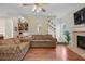Cozy living room with a fireplace, wood floors, sofas, and natural light at 2203 Arbor Hill Rd, Canton, GA 30115
