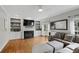 Inviting living room with fireplace, large TV, custom shelving, a gray sofa, and bright natural light at 2203 Arbor Hill Rd, Canton, GA 30115