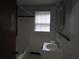 Bathroom with white tiling and contrasting black accent tiles around the perimeter of the room at 244 Hilltop Sw Dr, Atlanta, GA 30315