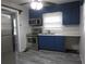 Kitchen features stainless steel appliances, blue cabinets, a double sink, and wood-look floors at 244 Hilltop Sw Dr, Atlanta, GA 30315