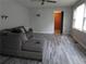 Living room with gray-toned walls and wood-look floors, ceiling fan and doorway view at 244 Hilltop Sw Dr, Atlanta, GA 30315