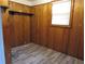Cozy room with wood paneling, wood-look floors, a bright window and shelving at 244 Hilltop Sw Dr, Atlanta, GA 30315