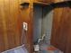 Cozy room with wood paneling, wood-look floors, shelving, and hookups for washer/dryer at 244 Hilltop Sw Dr, Atlanta, GA 30315