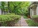 Charming backyard featuring a brick walkway surrounded by lush greenery at 245 Scotch Pine Ct, Alpharetta, GA 30022