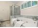 Spa-like bathroom with marble tile, glass enclosed shower, and jetted soaking tub at 245 Scotch Pine Ct, Alpharetta, GA 30022