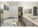 Bathroom with tub, shower, and double sink vanity with view to bedroom at 245 Scotch Pine Ct, Alpharetta, GA 30022