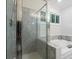 Bright bathroom featuring a shower and a tub with marble tile surround at 245 Scotch Pine Ct, Alpharetta, GA 30022