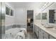 Well-lit bathroom with a double vanity, garden tub, and tiled shower at 245 Scotch Pine Ct, Alpharetta, GA 30022