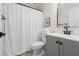 Well-lit bathroom featuring a white shower curtain, toilet, and grey vanity at 245 Scotch Pine Ct, Alpharetta, GA 30022