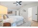 Bright bedroom featuring a tufted headboard, ceiling fan, and ensuite bath at 245 Scotch Pine Ct, Alpharetta, GA 30022