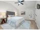 Well-lit bedroom featuring a tufted headboard, ceiling fan, and decorative rug at 245 Scotch Pine Ct, Alpharetta, GA 30022