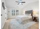 Bright bedroom showcasing a tufted headboard, ceiling fan, and decorative rug at 245 Scotch Pine Ct, Alpharetta, GA 30022