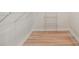 Spacious walk-in closet with laminate flooring and built-in shelving at 245 Scotch Pine Ct, Alpharetta, GA 30022