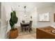 Elegant dining room with a modern chandelier and view into the kitchen at 245 Scotch Pine Ct, Alpharetta, GA 30022