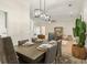 Dining room with seating for six, modern chandelier and decor at 245 Scotch Pine Ct, Alpharetta, GA 30022