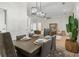 Bright dining room with a modern chandelier and room for six, adjacent to the living area at 245 Scotch Pine Ct, Alpharetta, GA 30022