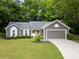 Charming one-story home with a well-maintained lawn, yellow door, and an attached two-car garage at 245 Scotch Pine Ct, Alpharetta, GA 30022