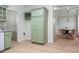 Kitchen area with green cabinets, wine rack and view into breakfast nook at 245 Scotch Pine Ct, Alpharetta, GA 30022