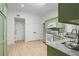Inviting kitchen with light green cabinetry and stainless-steel appliances at 245 Scotch Pine Ct, Alpharetta, GA 30022